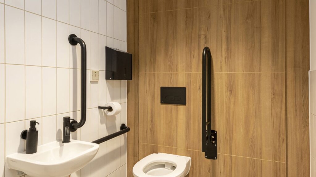 Accessible Toilet with full-height duct panels.