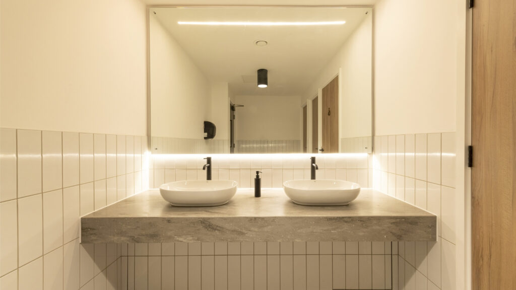 2 table top sinks on a floating solid surface vanity top