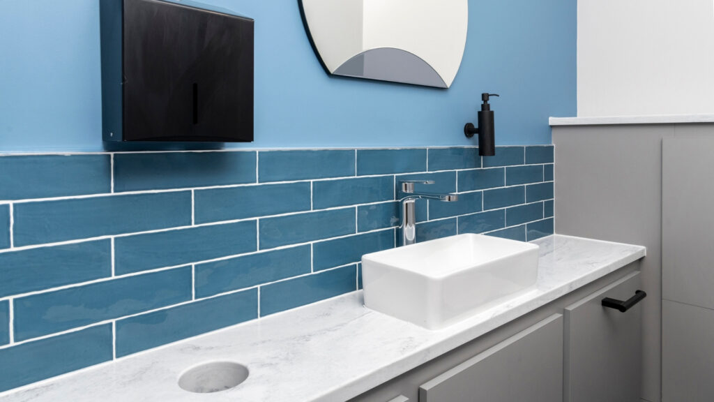 Solid surface vanity top with formed bin chute and table top sink